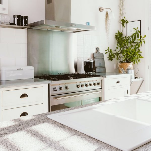 Scandinavian style kitchen with fridge, oven and kitchen island with sink